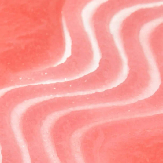 Close-up of TREE HUT Sugar Scrub Strawberry texture, showcasing creamy pink swirls for smooth and nourished skin.