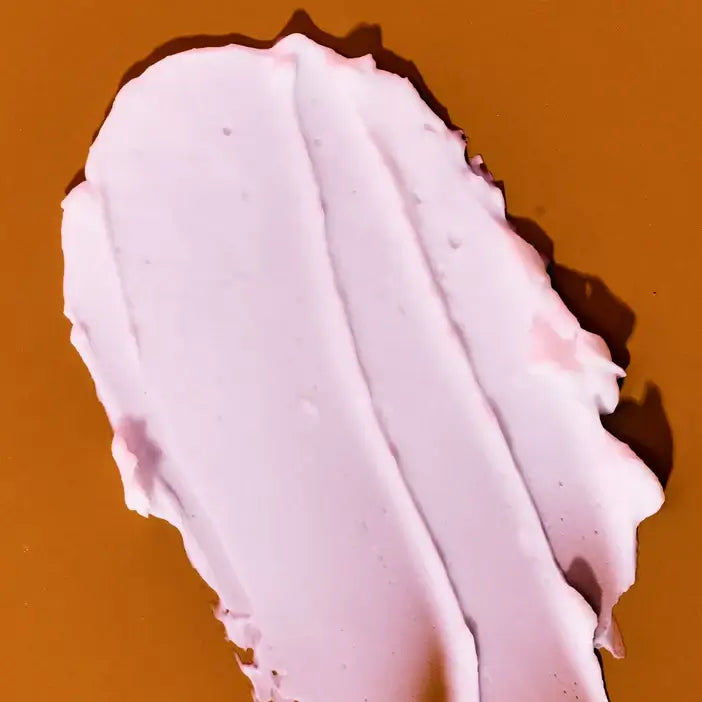 Close-up of a pink texture of TREE HUT Coco Colada Whipped Body Butter on a brown background