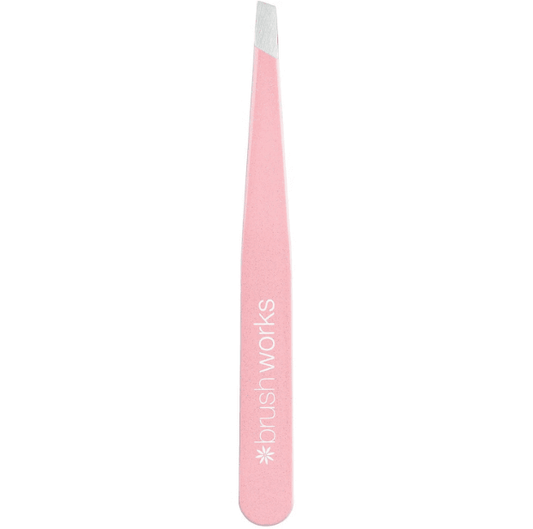 Brushworks Precision Slanted Tweezers in pink, crafted from stainless steel for eyebrow grooming and eyelash application.