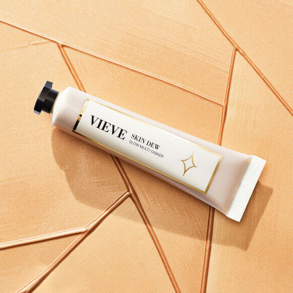 VIEVE Skin Dew 20ml: liquid highlighter for radiant skin on a textured background.