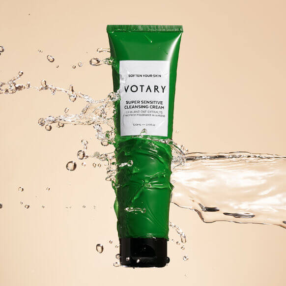 VOTARY Super Sensitive Cleansing Cream tube surrounded by splashing water, ideal for gentle care of sensitive skin.