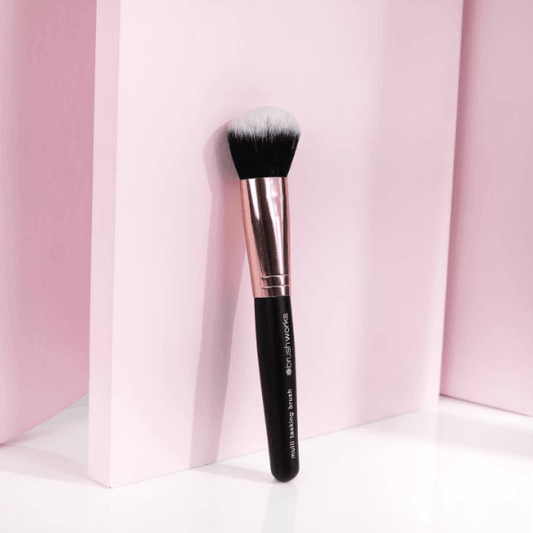 Brushworks Multi Tasking Brush against a pink background, ideal for stippling, blending, and buffing makeup flawlessly.