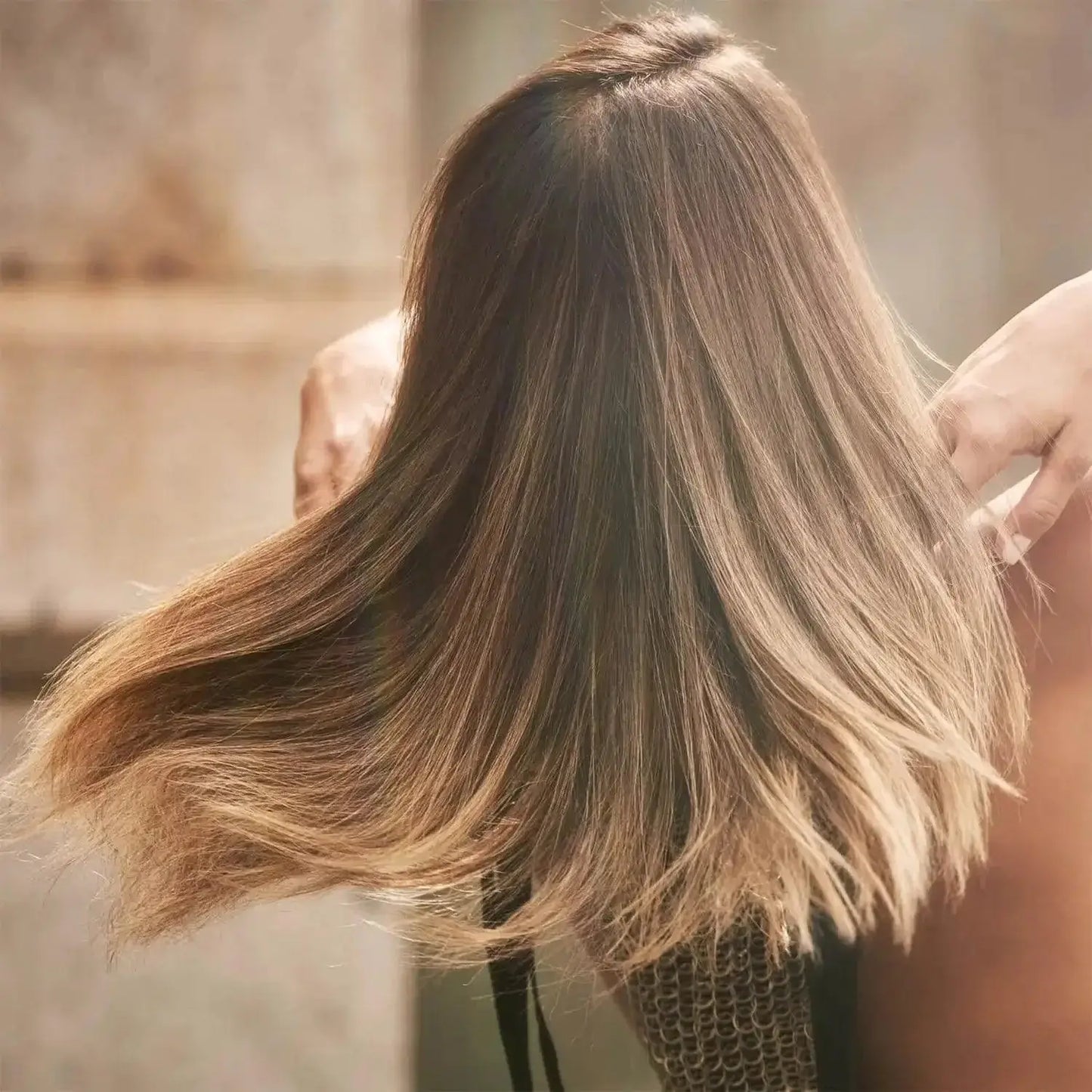 Model showcasing soft, shiny hair after using Bumble BB Dry Spun Spray for added volume and texture.