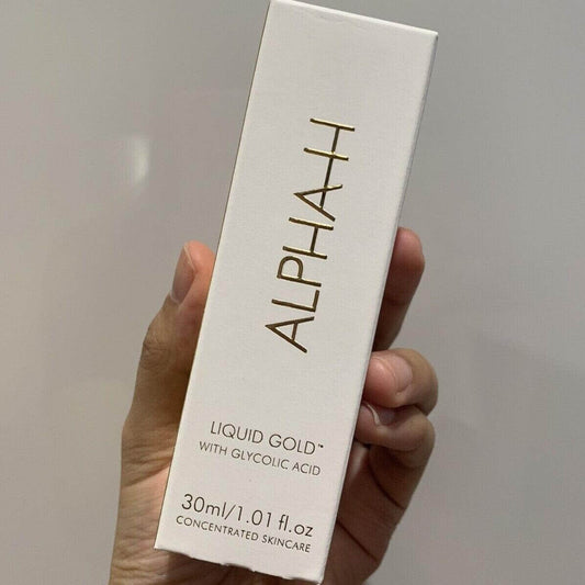 Alpha-H Liquid Gold with 5% Glycolic Acid packaging in hand for effective skincare.