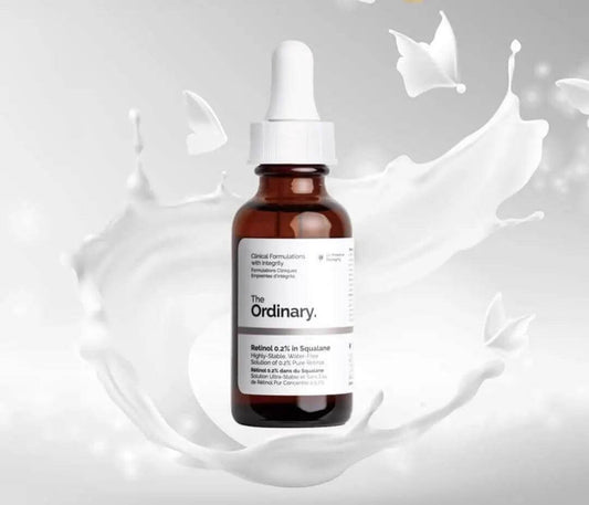The Ordinary Retinol 0.2% in Squalane 30ml bottle surrounded by flowing cream background.