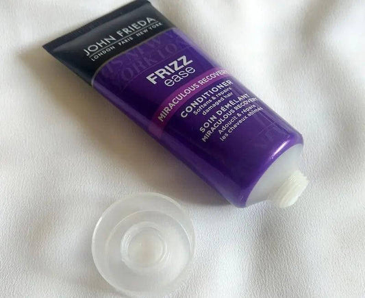 John Frieda Frizz Ease Miraculous Recovery Conditioner 50ml tube for damaged hair repair and moisturizing treatment.