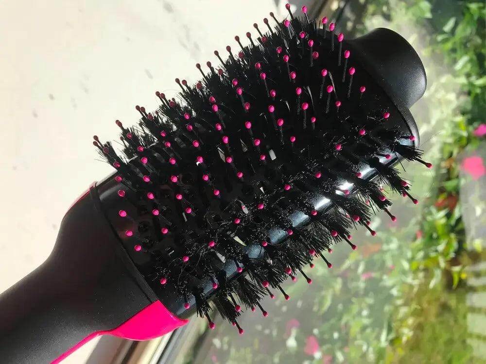Close-up of Revlon Pro Collection One Step Dryer & Volumiser, featuring its unique oval design and bristle technology.