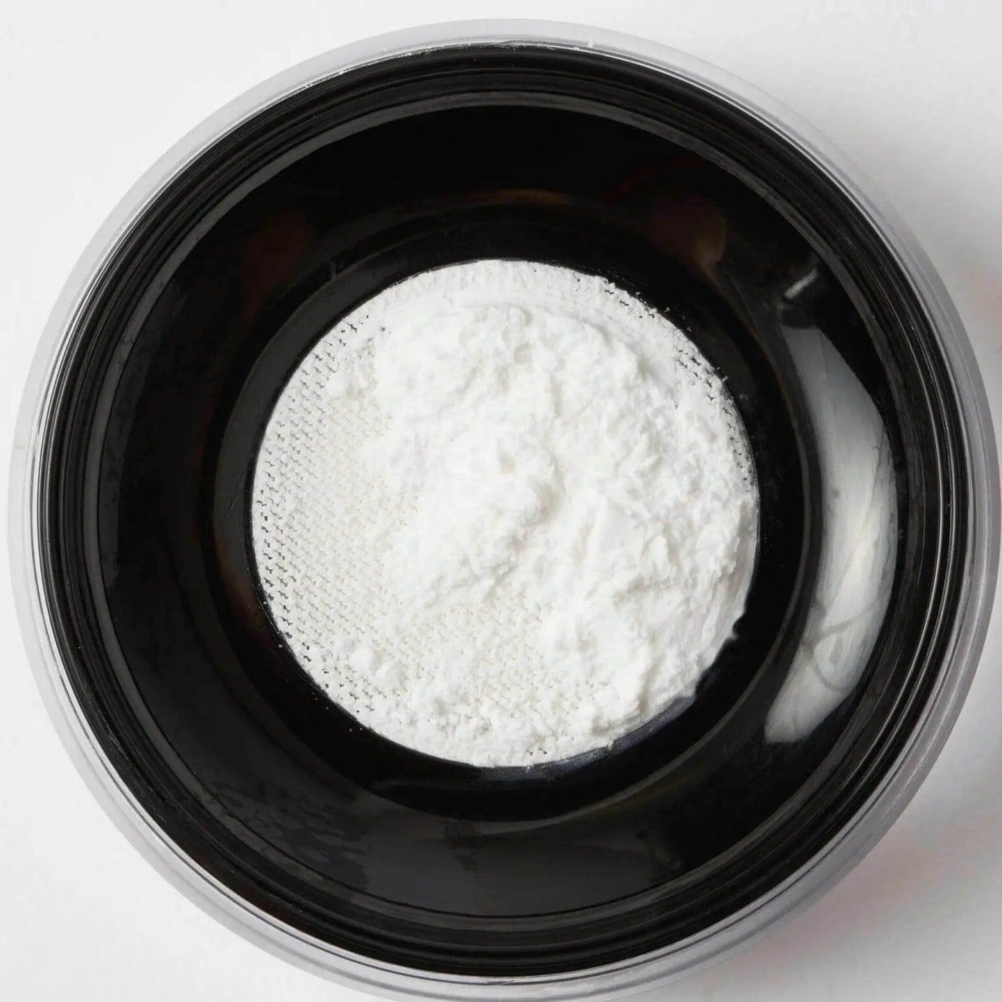 Revolution Pro Translucent Hydra-Matte Setting Powder in a black container, showcasing ultra-fine translucent powder.