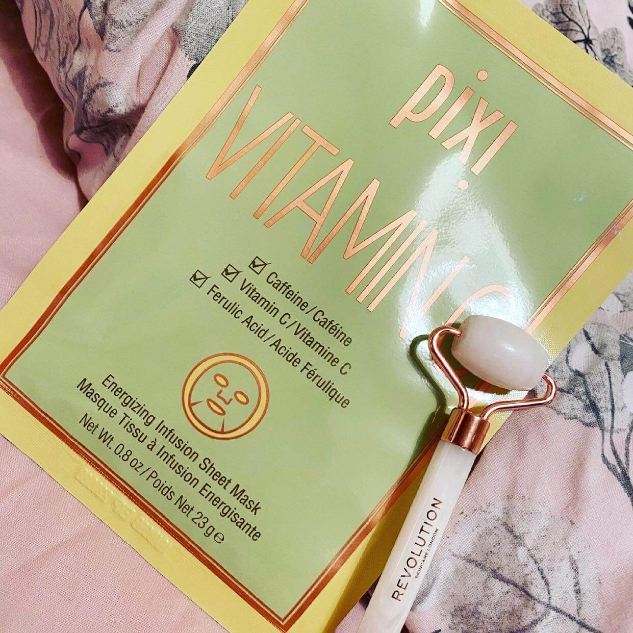 Pixi Vitamin-C Sheet Mask packaging with a jade roller, highlighting vitamin C and caffeine for brightening and energizing skin.