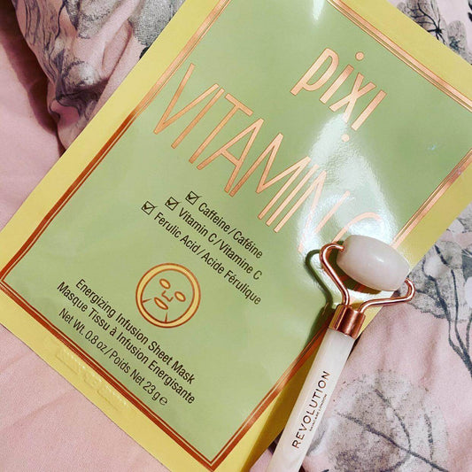 Pixi Vitamin-C Sheet Mask packaging with a jade roller, highlighting vitamin C and caffeine for brightening and energizing skin.