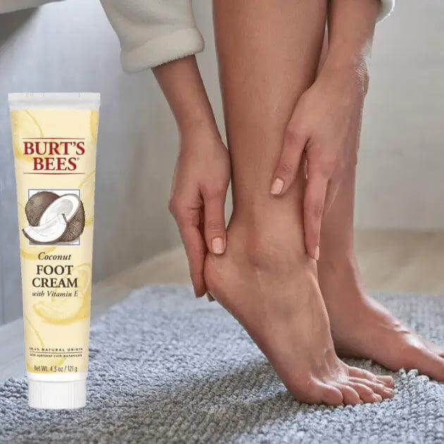 Burt's Bees Coconut Foot Cream being applied on a woman's foot, offering hydration and nourishment for dry skin.