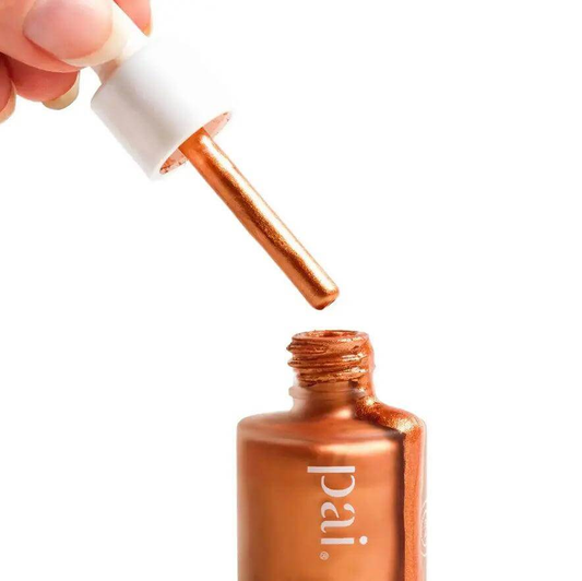 Pai Skincare The Impossible Glow Bronzing Drops in copper bottle with dropper.