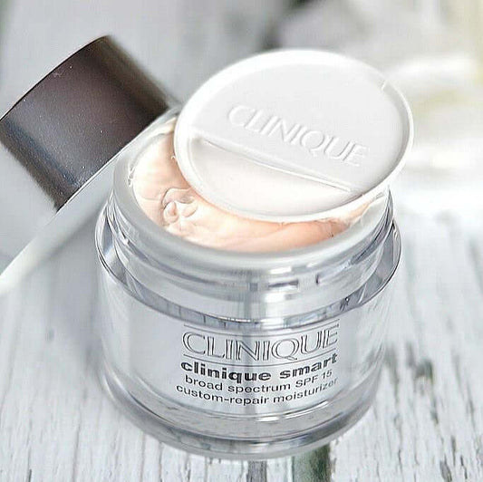 CLINIQUE Smart™ SPF 15 Custom Moisturizer jar with lid open, showcasing the cream inside for radiant skin care.