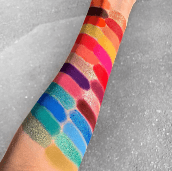 Swatches of the LaRoc Cosmetics PRO Artistry Book Eyeshadow Palette showcasing vibrant 48 shades on an arm.