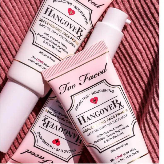 Too Faced Hangover Replenishing Primer tubes on a textured background, highlighting skin-nourishing ingredients.