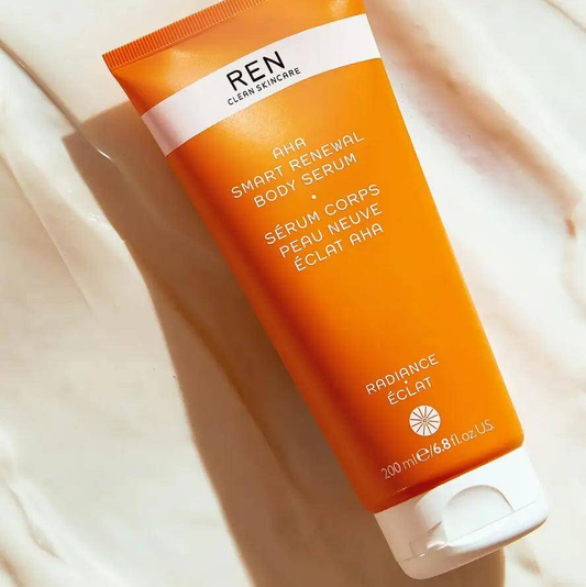 Ren Clean Skincare AHA Smart Renewal Body Serum 200ml in bright orange tube on white background.