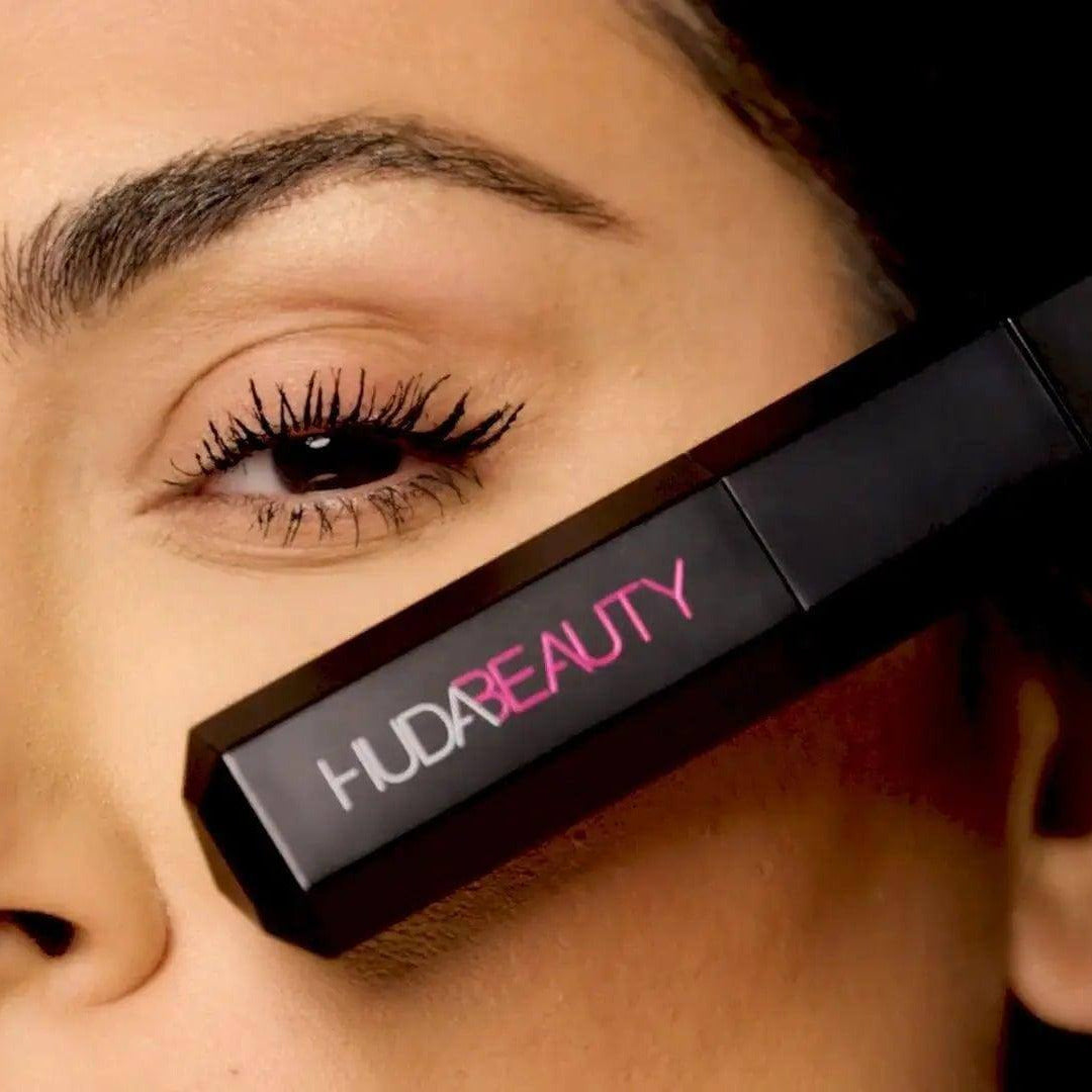 Close-up of HUDA Beauty Legit Lashes Double-Ended Mascara showcasing dramatic lashes and sleek packaging.