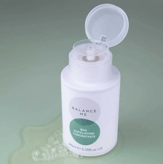 Balance Me BHA Exfoliating Concentrate 180ml bottle with cap open, designed for blemish-prone skin, on a soft green background.
