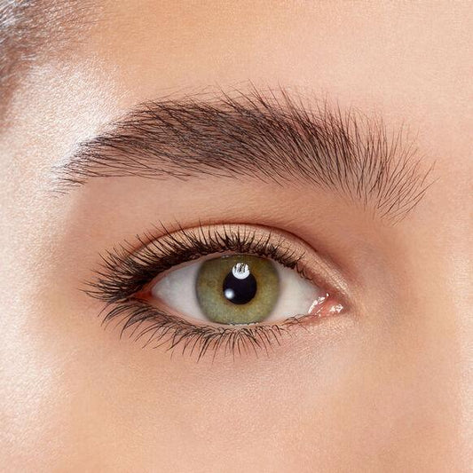 Close-up of a model's eye wearing Eyeko Black Magic Mascara, showcasing volume and defined lashes.
