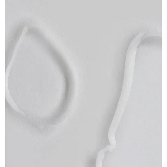 Close-up of The INKEY List Glycolic Acid Toner texture on a smooth surface, showcasing its lightweight, creamy consistency.