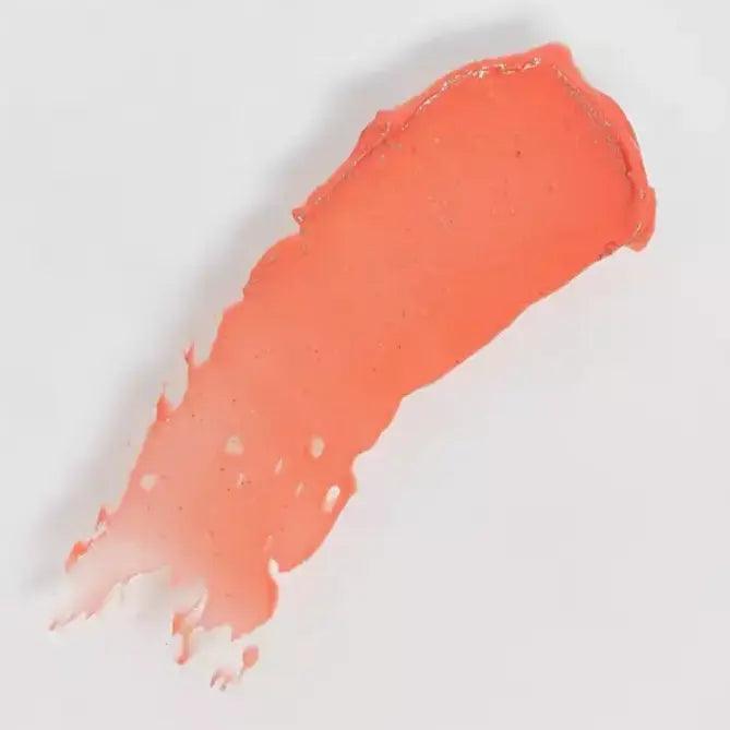 Peach pink balm swatch showcasing a smooth, vibrant texture suitable for lips and cheeks.
