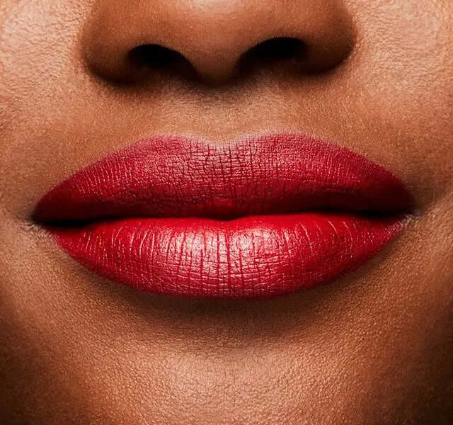 Close-up of lips wearing MAC Retro Matte Lipstick in Ruby Woo, showcasing vivid blue-red color with a matte finish.