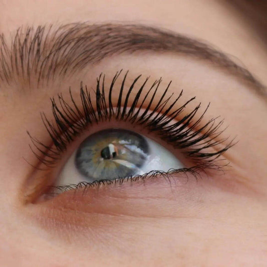 Close-up of eye with long, voluminous lashes enhanced by MAC In Extreme Dimension 3D Black Mascara.
