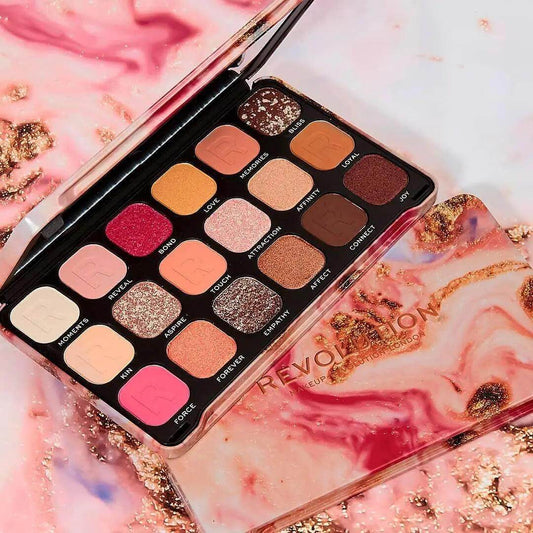 Revolution Makeup Forever Flawless Affinity Palette with 18 vibrant eyeshadows on a marbled background.