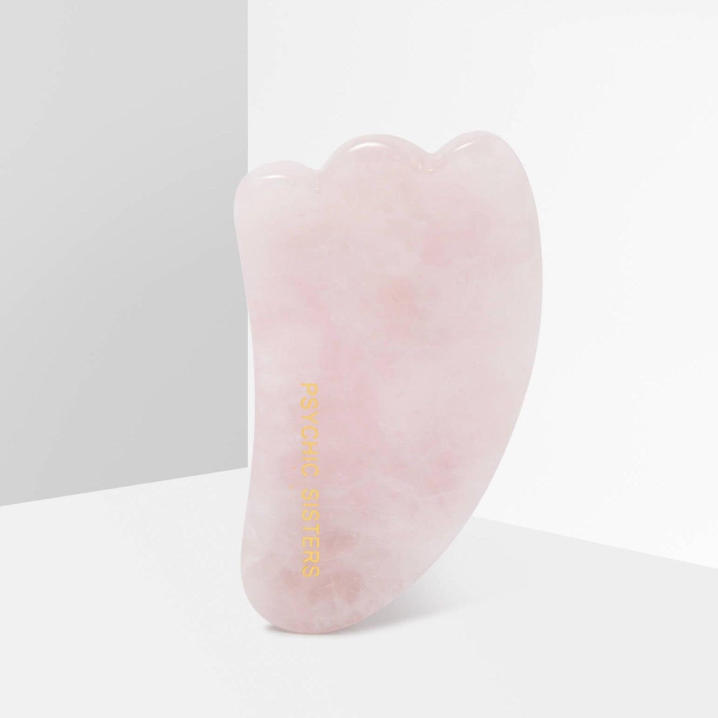 Psychic Sisters Rose Quartz Gua Sha facial wand for skin rejuvenation and holistic well-being.