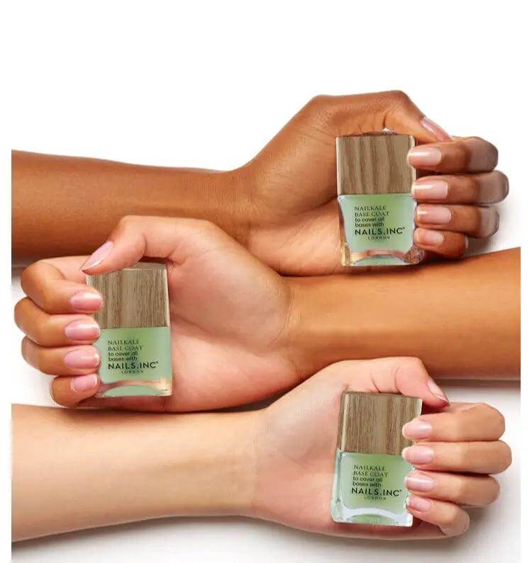 Nails.INC NailKale Superfood Base Coat bottles held by diverse hands showcasing healthy nails.