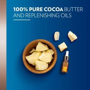 Bowl of pure cocoa butter chunks with replenishing oils on a blue background.