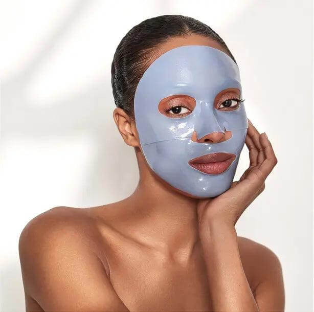 Woman applying 111SKIN Cryo De-Puffing Energy Mask for radiant, energized skin and reduced puffiness.