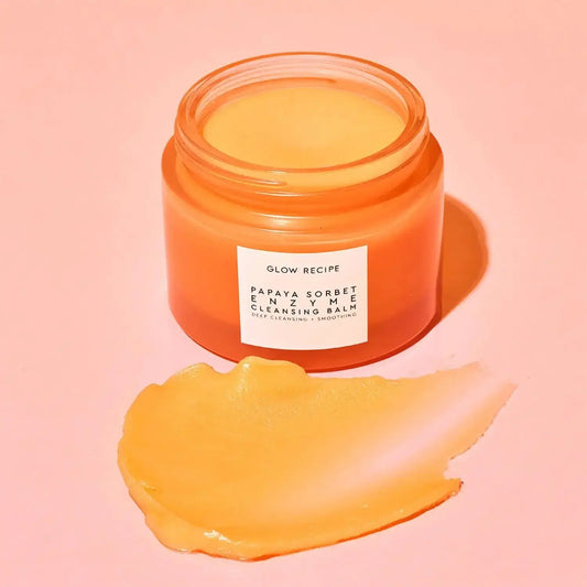 GLOW RECIPE Papaya Enzyme Cleansing Balm in jar with a sorbet texture on a pink background.