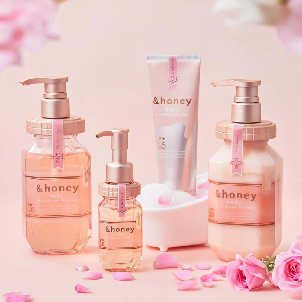 Skincare products with 'honey' branding on a pink background with flowers.