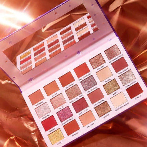 CIATE London I Am Woman 24 Shade Eyeshadow Palette V2 showcasing rich, highly-pigmented shades on a pink background.
