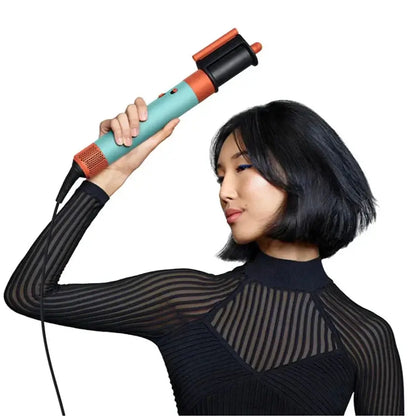 Dyson Airwrap I.D. Patina & Topaz hairstyling tool held by model with sleek bob haircut.
