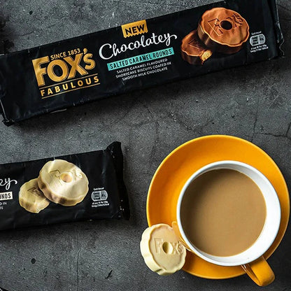 Fox's Fabulous chocolate buns packaging with a cup of coffee on a dark surface