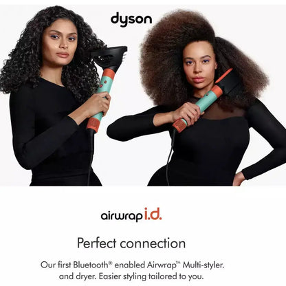 Two women showcasing Dyson Airwrap i.d. hair styling tools, perfect for curly to coily hair textures.