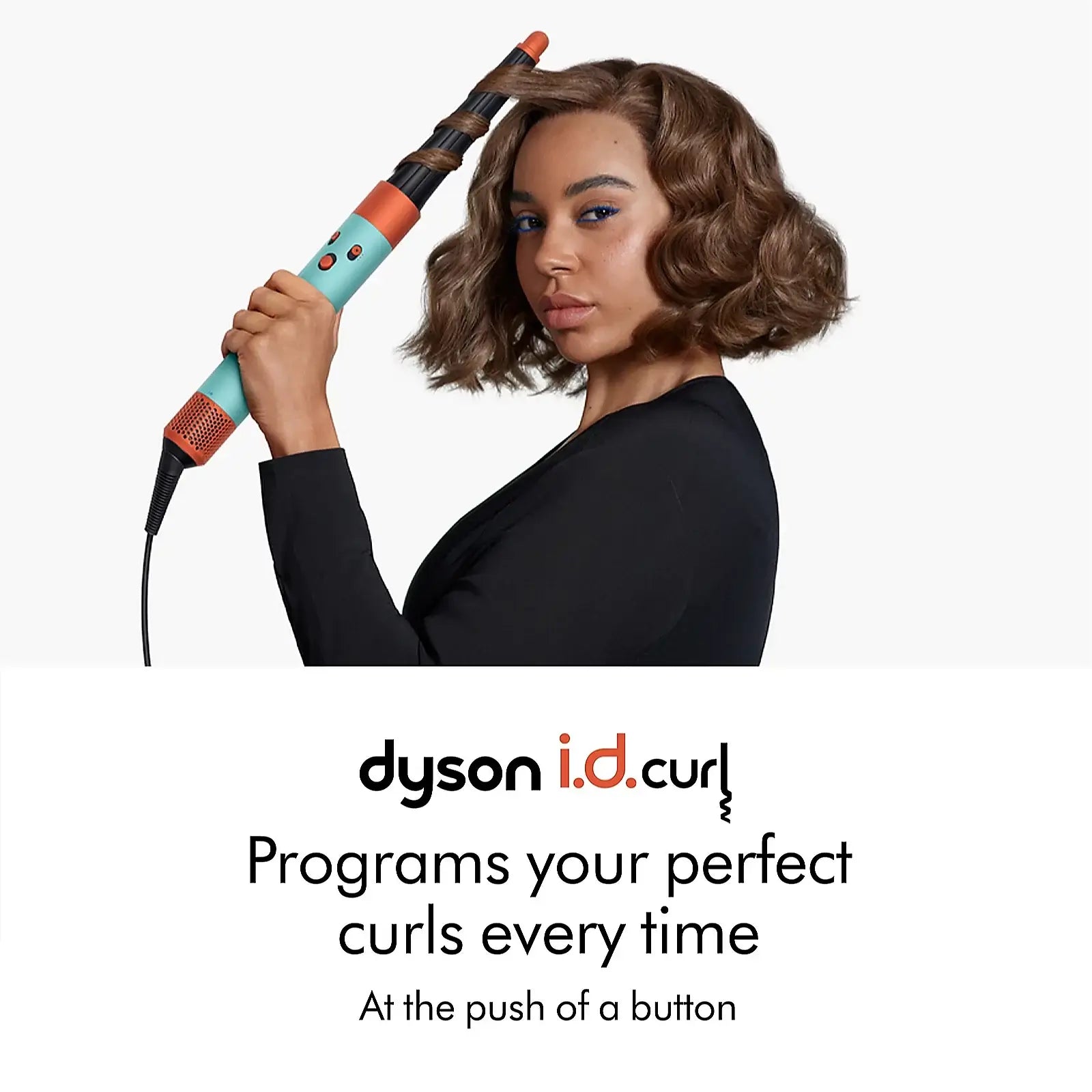 Woman using Dyson Airwrap I.D. Curl hair tool for flawless curls with ease.