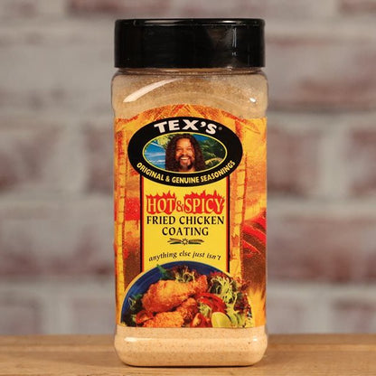 Tex's Hot & Spicy Fried Chicken Coating seasoning jar on a wooden surface with a brick wall background.
