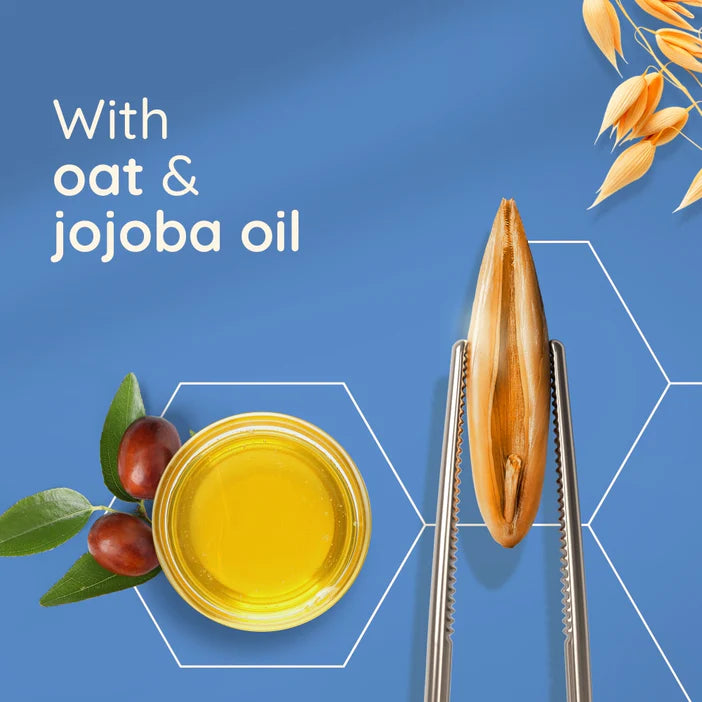 Aveeno Skin Relief Body Oil Spray with oat and jojoba oil on a blue background