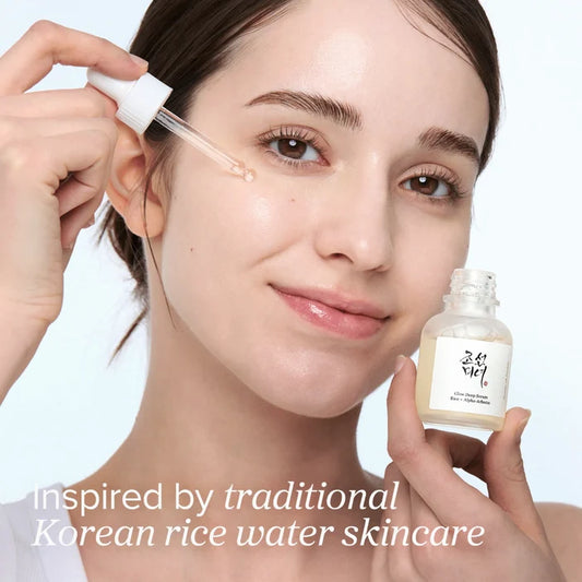 Woman applying a skincare product with text 'inspired by traditional Korean rice water skincare'.