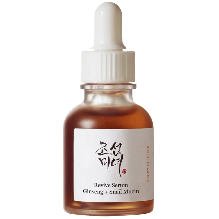 A small amber glass dropper bottle with a white cap and a white label reading 'Revive Serum Ginseng + Snail Mucin' on a plain white background.