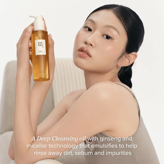 Woman holding a bottle of deep cleansing oil with text describing its benefits.