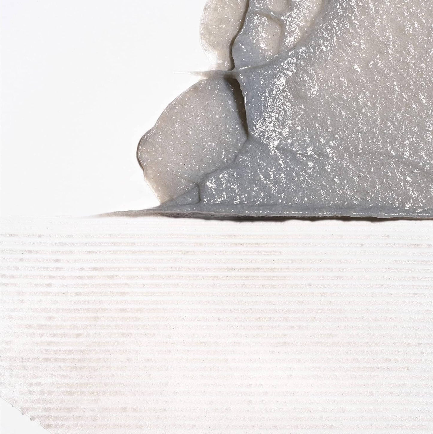 Close-up of a textured gray surface with a white background