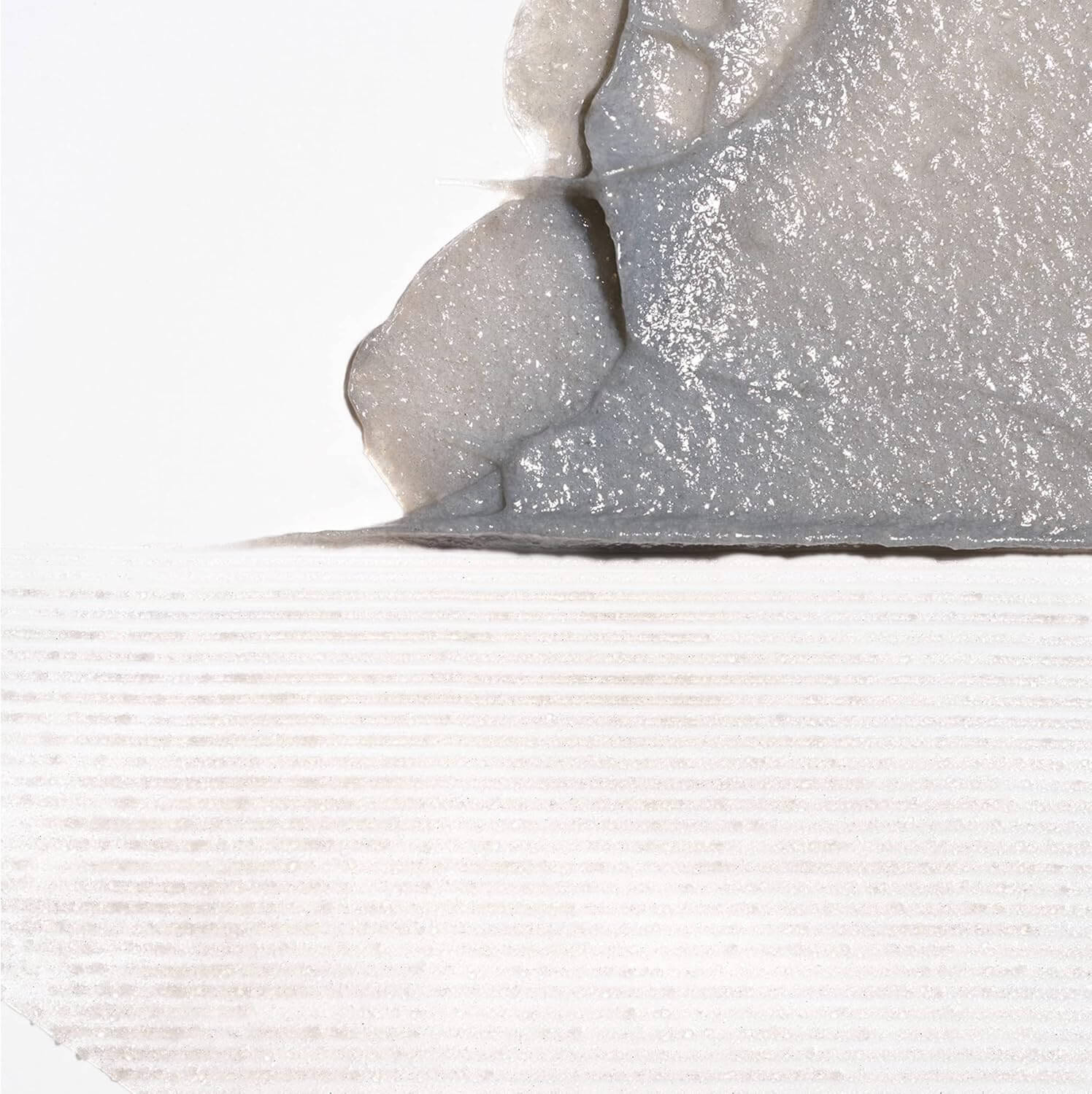 Close-up of a textured gray surface with a white background