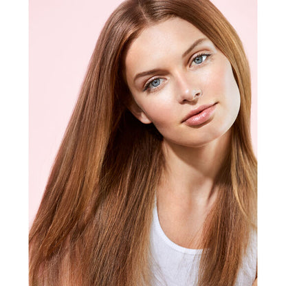 Woman with long, straight brown hair against a pink background Briogeo deep conditioning mask