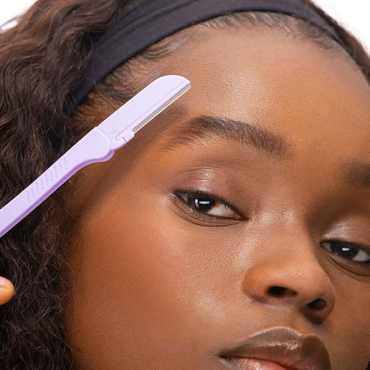 Brushworks Eyebrow Razor being used to shape brows, offering pain-free hair removal and gentle exfoliation.