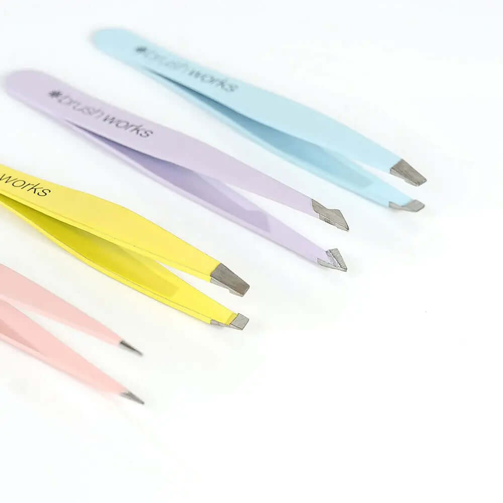 Brushworks HD combination tweezer set in pastel colors for precise eyebrow grooming and maintenance.