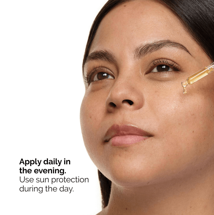 Woman applying The Ordinary Retinol 0.5% in Squalane serum on her face, promoting evening skincare routine.